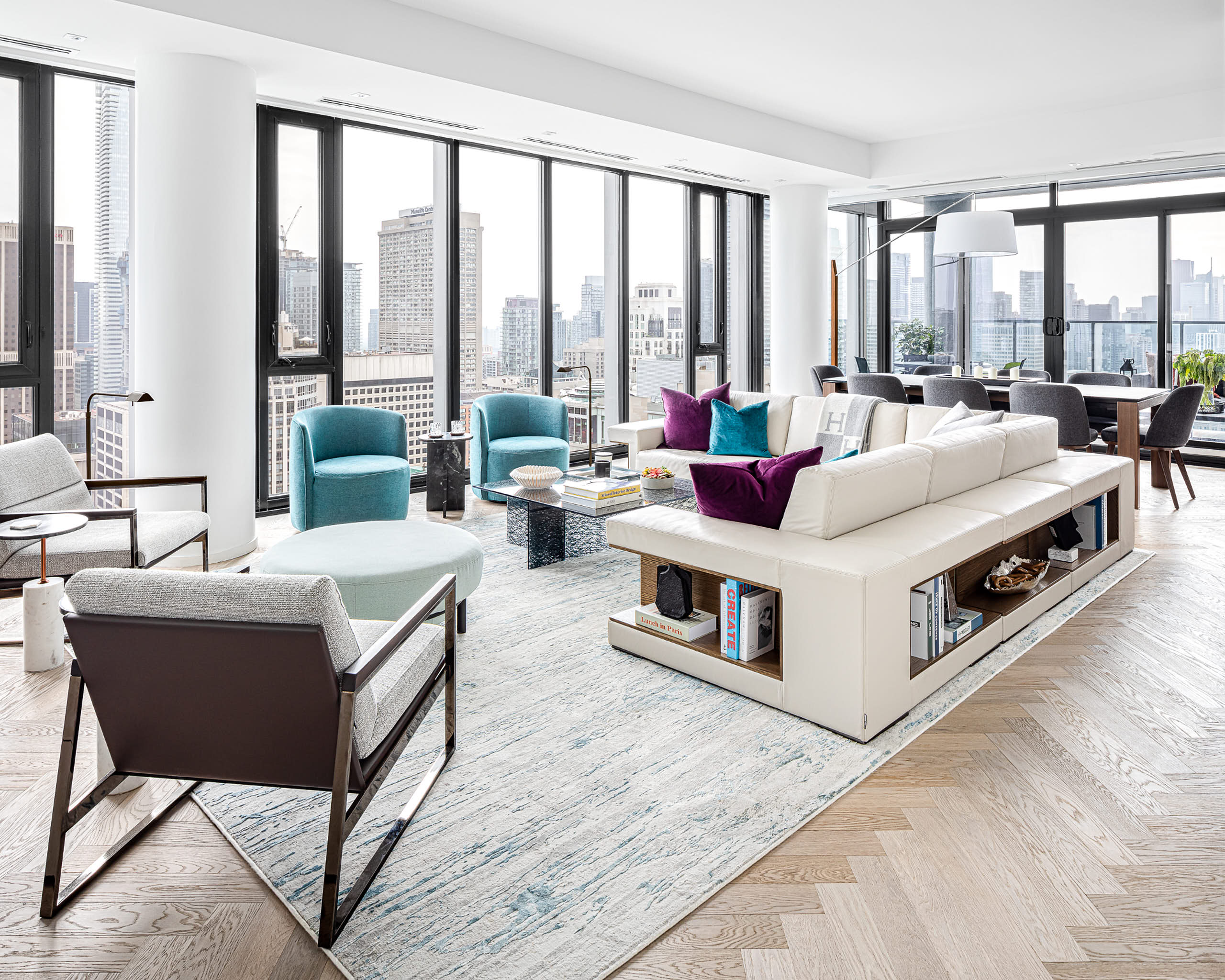 Expansive Yorkville living room designed for entertaining, featuring low-profile Italian furniture and floor-to-ceiling panoramic views.