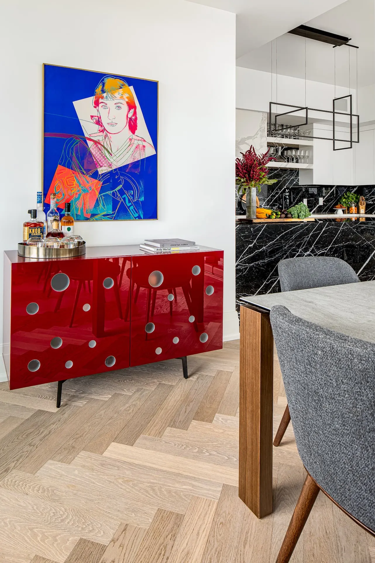 Andy Warhol print of Wayne Gretzky signed by both above a burgundy sideboard