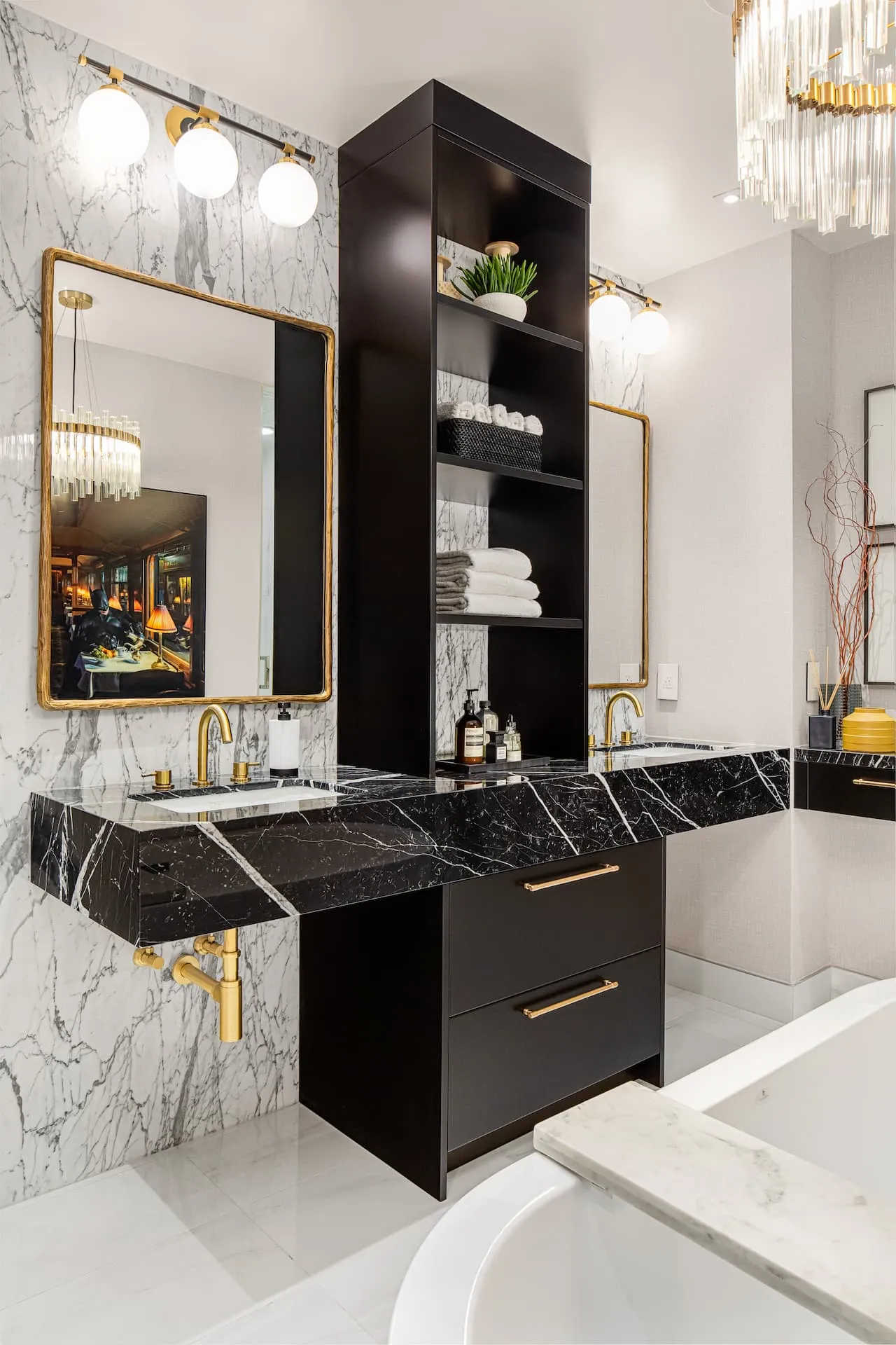 Black and white marble double vanity paired with gold hardware in an ensuite