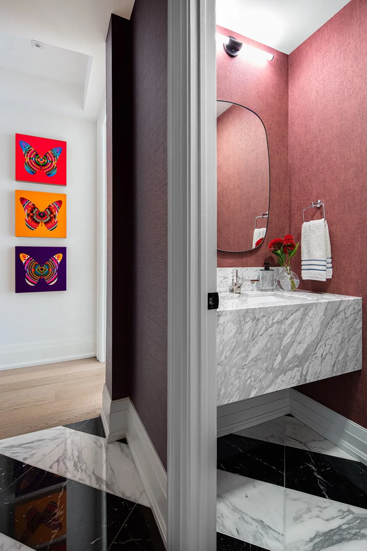 Vinh and Luca of Level Studio in a Yorkville powder room with a marble sink and colourful wallpaper