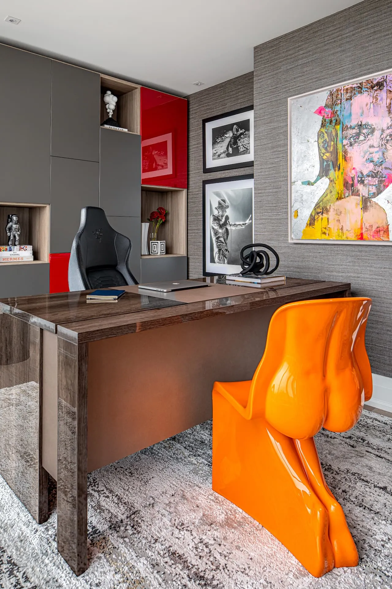 Original Craig Alan artwork above a desk and striking orange Her Chair