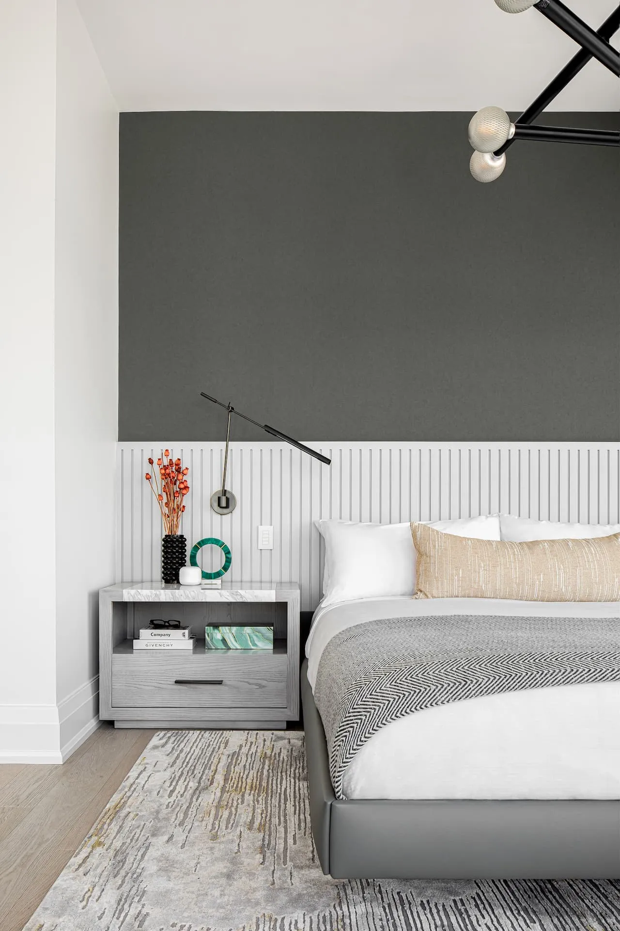 Grey fluted headboard with dark grey textured wallpaper and quartz slab