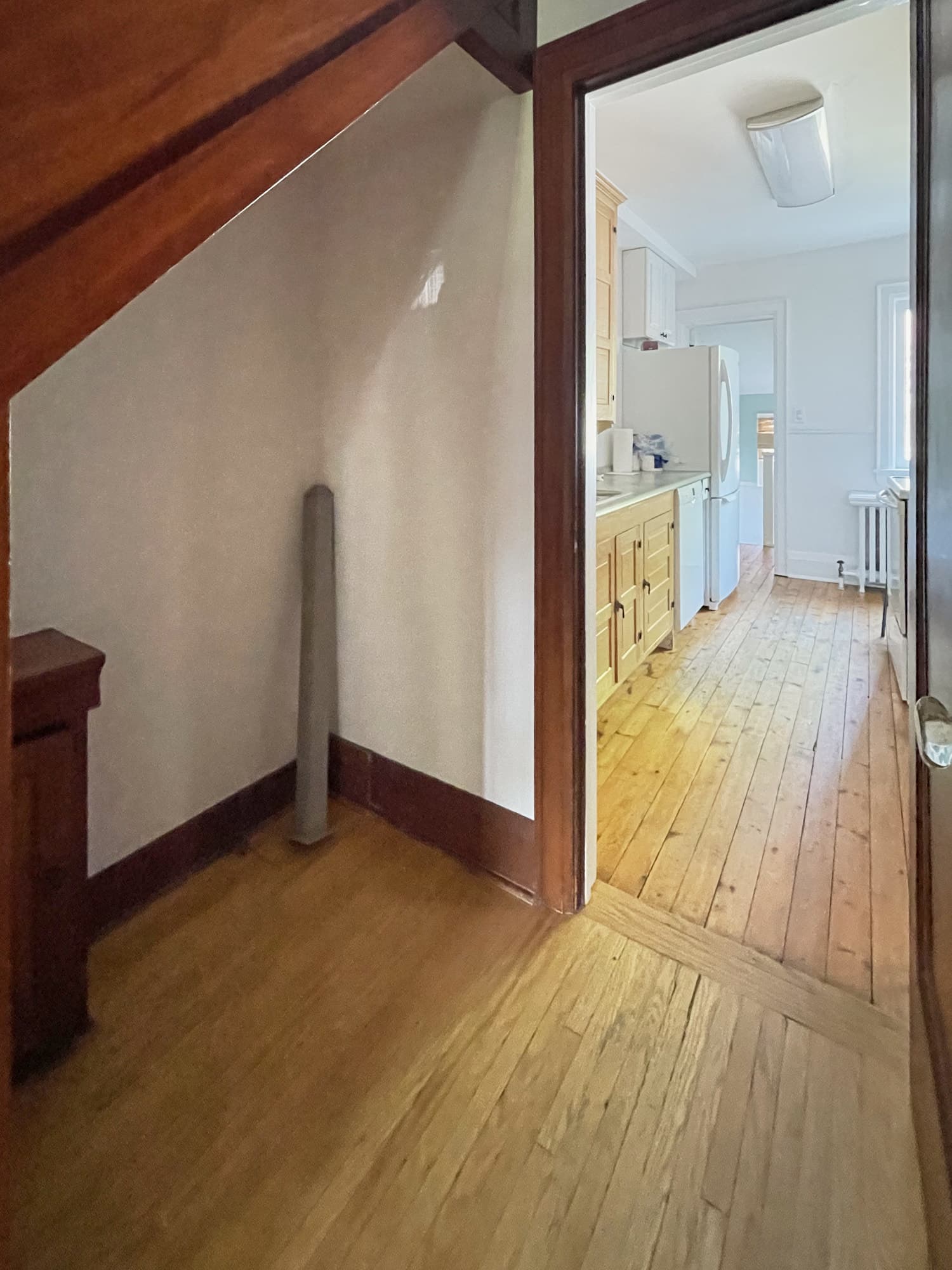 Empty space under the staircase before the powder room conversion