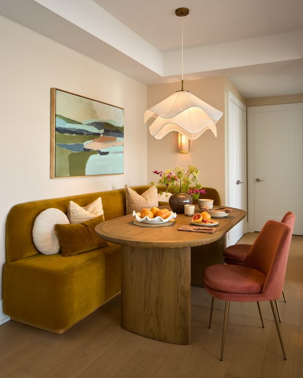 Open floor space between the kitchen island and the corner banquette dining table