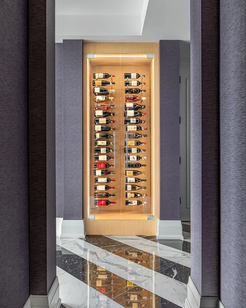 Custom illuminated wine display in rift cut white oak in an alcove