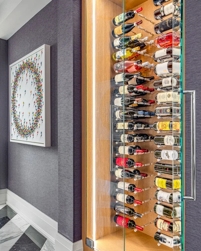 Custom illuminated wine display in a hallway alcove