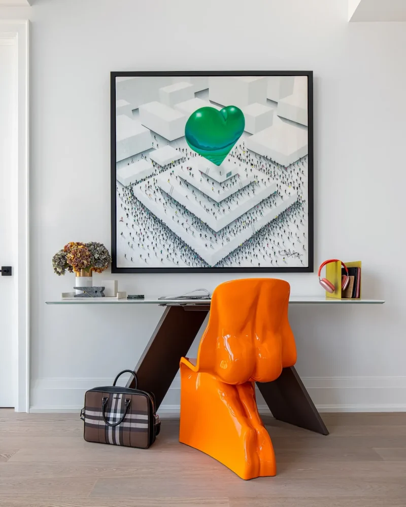 Yorkville Condo Design Primary Bedroom: Modern office nook in a Yorkville primary suite featuring a porcelain top desk, an orange Her chair, and Craig Alan artwork.